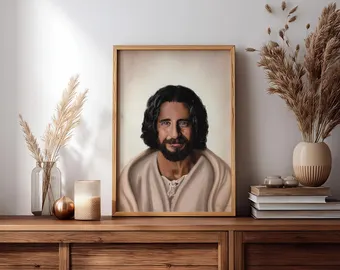 Framed Jonathan Roumie portrait on a shelf